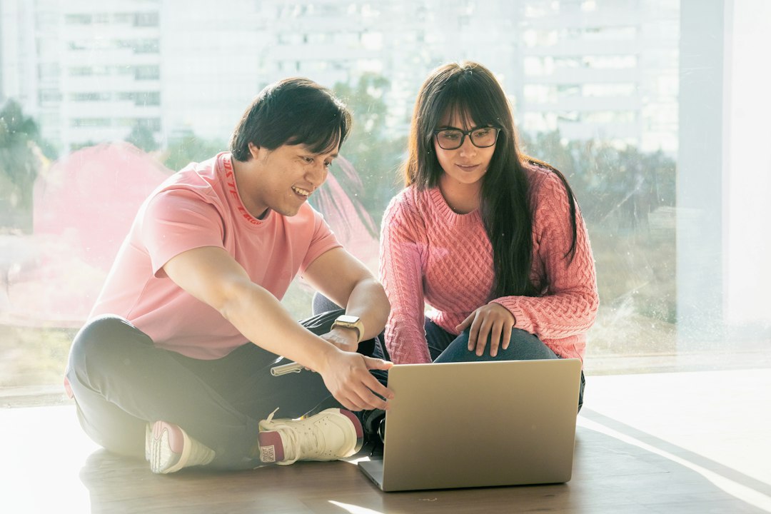 A couple looking at a laptop together as they make plans.